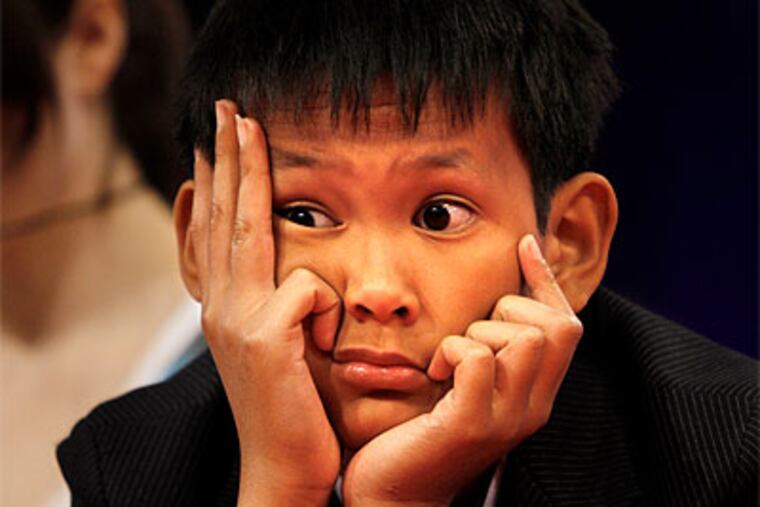 Vothom Son Lu, 11, of Camden, N.J., listens to fellow competitors while on stage at the 2010 Scripps National Spelling Bee in Washington, on Thursday. (AP Photo / Jacquelyn Martin)