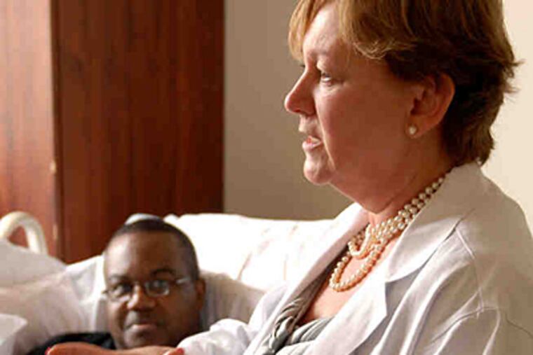 Patricia Ford, a doctor at Pennsylvania Hospital, visits patient Jock Davis, whose religion bans use of blood transfusions. (Tom Gralish/Staff)