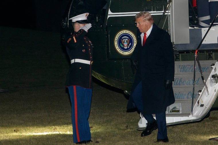 President Donald Trump greets a Marine Corps honor guard as he disembarks Marine One upon arrival on the South Lawn of the White House in Washington, Monday, Jan. 27, 2025.
