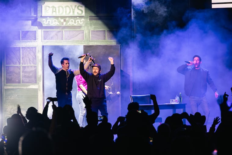 Rob McElhenney (from left), Charlie Day, and Glenn Howerton enter the stage at the Mann Center through a Paddy's Pub door.