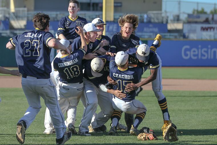 Devon Prep pitcher Andrew Czachor (17) gets tackled by teammates after beating Serra Catholic for the PIAA Class 2A state championship.