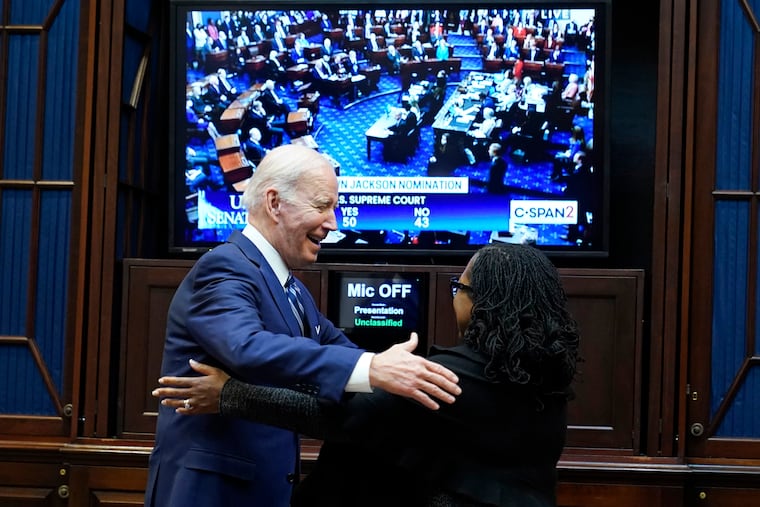 President Joe Biden goes to hug Supreme Court nominee Judge Ketanji Brown Jackson as they watch the Senate vote on her confirmation from the Roosevelt Room of the White House in Washington, Thursday, April 7, 2022.