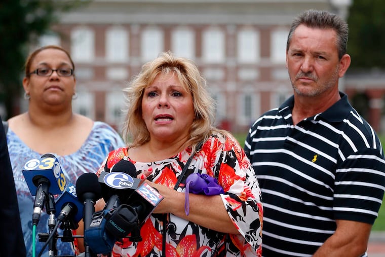 Plaintiffs from left Norys Hernandez and Markela and Chris Sourovelis take part in a news conference, Tuesday, Aug. 12, 2014, in view of Independence Hall in Philadelphia. A lawsuit was filed in federal court in Philadelphia alleging that the city has been seizing and selling millions in property from city residents, including those not charged with crimes. (AP Photo/Matt Rourke)