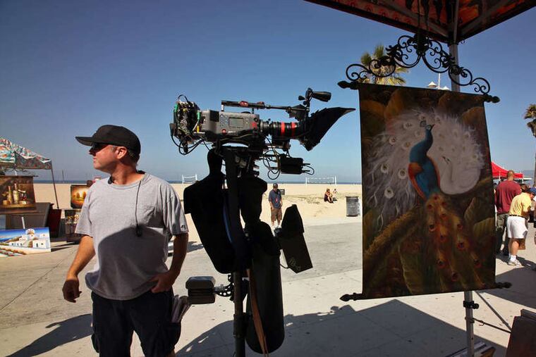 The crew gets cameras ready while shooting a scene of "NCIS: Los Angeles" on Ocean Front Walk in Venice, Calif.