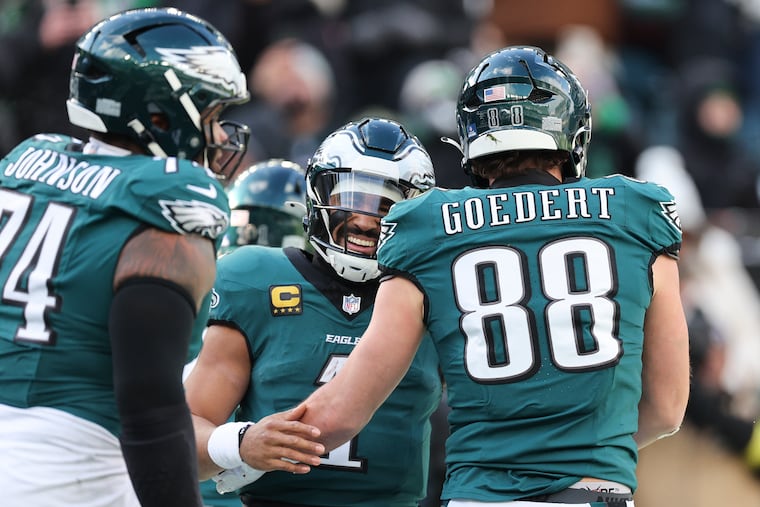 Jalen Hurts is all smiles as he congratulates tight end Dallas Goedert on his first-quarter touchdown catch against the Raiders.