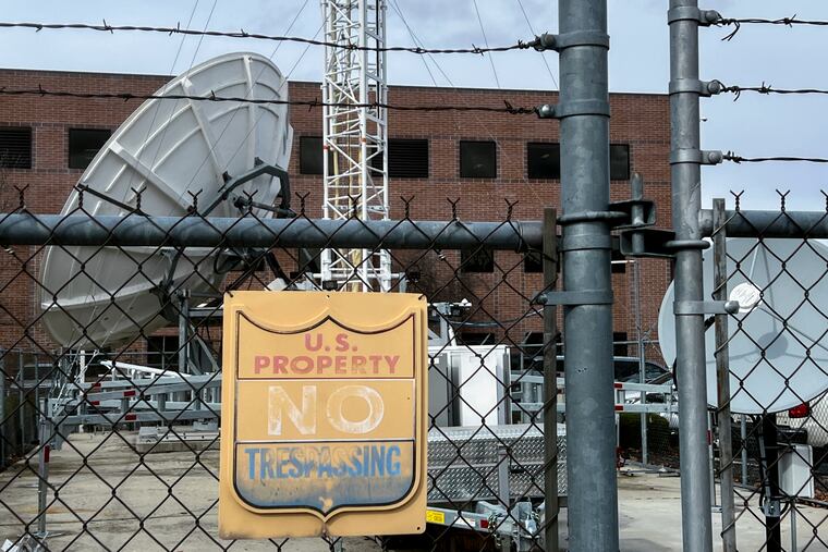 A chain link fence protects a satellite station and other equipment behind the Bureau of Reclamation office in Boise, Idaho, on Thursday, March 13, 2025.