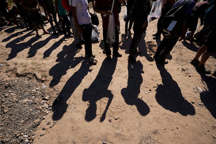 Migrants wait to be processed by U.S. Customs and Border Protection after they crossed the Rio Grande and entered the U.S. from Mexico, Oct. 19, 2023, in Eagle Pass, Texas.