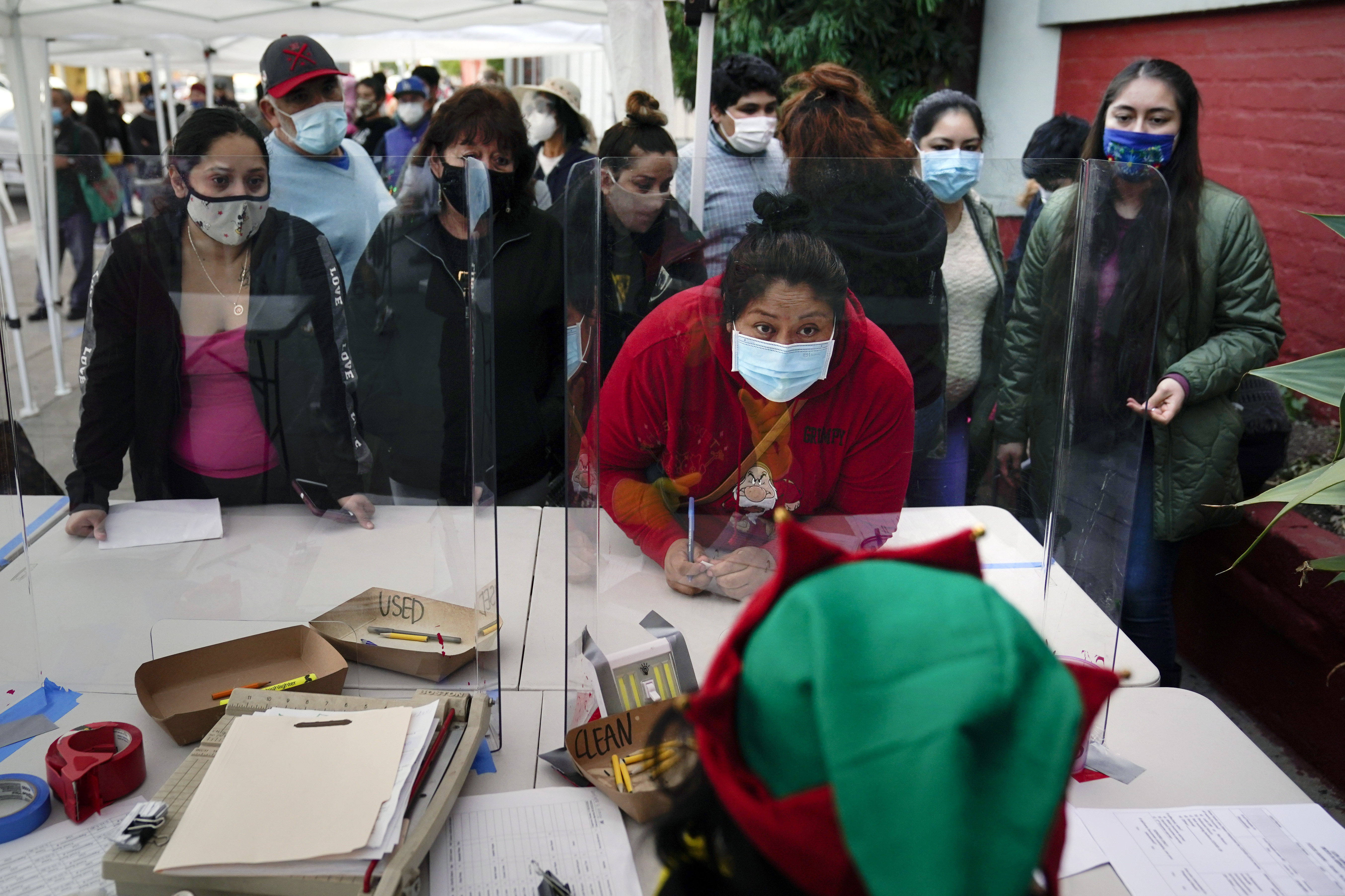 People check in at a food bank held at Los Angeles Boys & Girls Club in the Lincoln Heights neighborhood of Los Angeles last month.
