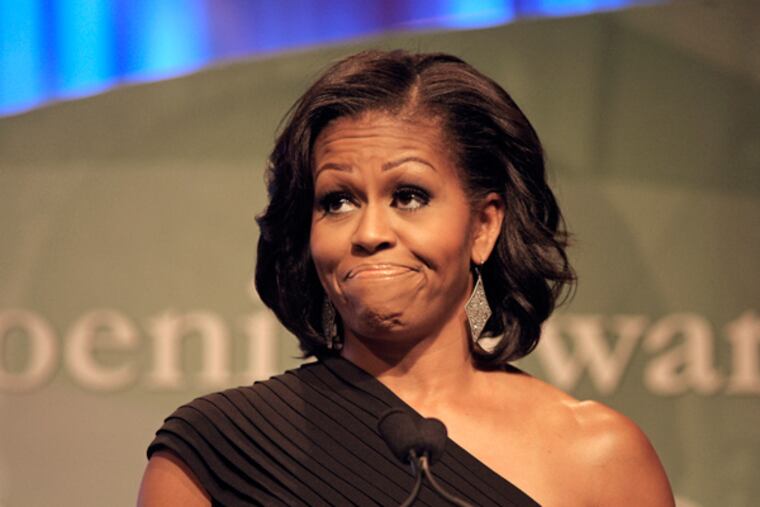 FILE - First lady Michelle Obama addresses the Congressional Black Caucus Foundation's 42nd Annual Phoenix Awards dinner in Washington, in this, Sept. 22, 2012 file photo. Mrs. Obama was speaking Tuesday, June 4, at a Democratic National Committee fundraiser in Washington. According to a report, an audience member started shouting in support of an executive order on gay rights halfway through Mrs. Obama's remarks. (AP Photo/Cliff Owen, File)