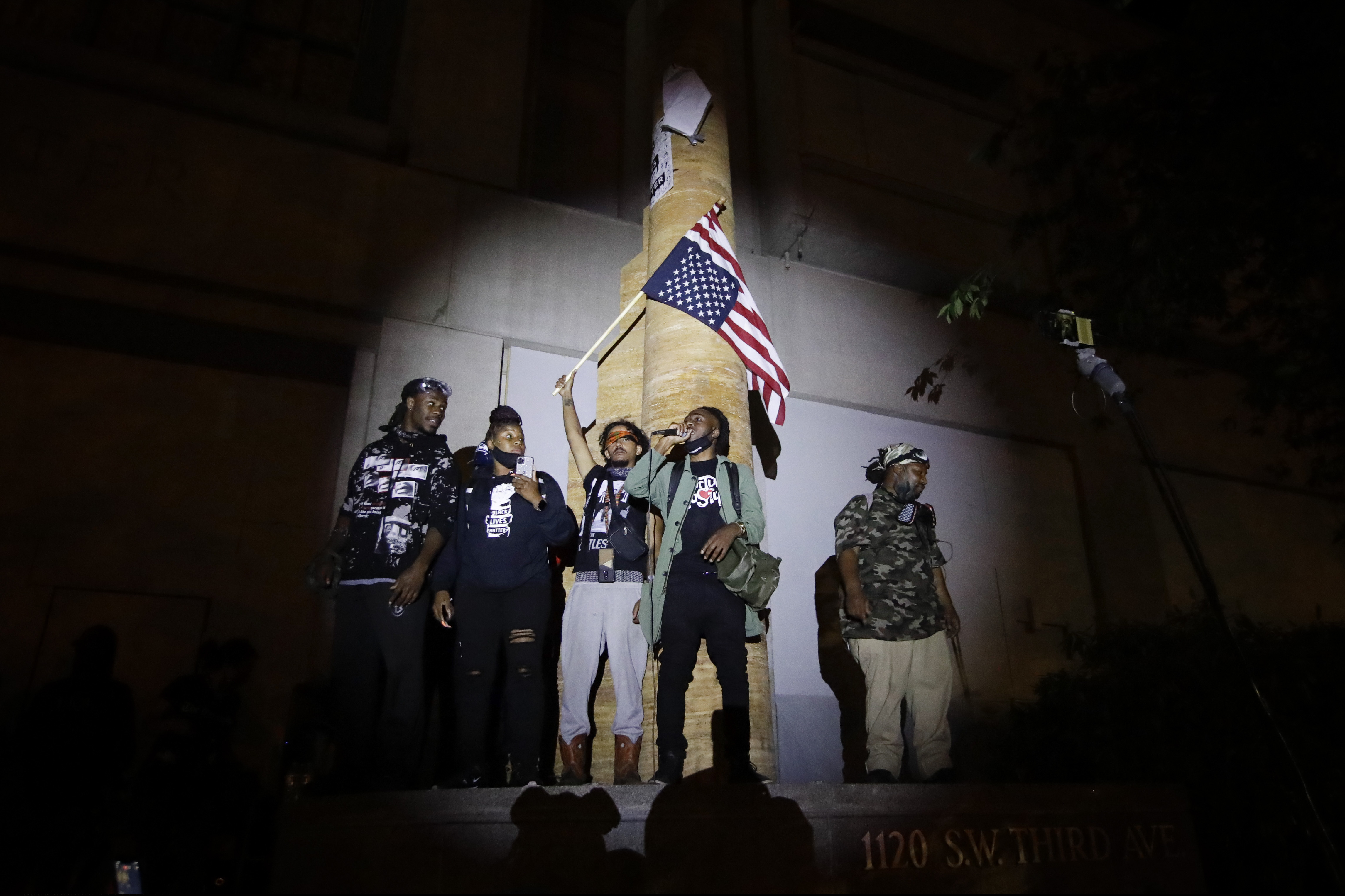 A group of demonstrators addresses the crowd during a Black Lives Matter protest at the Mark O. Hatfield U.S. Courthouse in Portland, Ore., on Thursday.