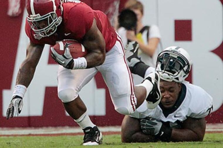 Alabama running back Trent Richardson pulls away from Penn State's Devon Still in the first quarter. (AP Photo/Dave Martin)