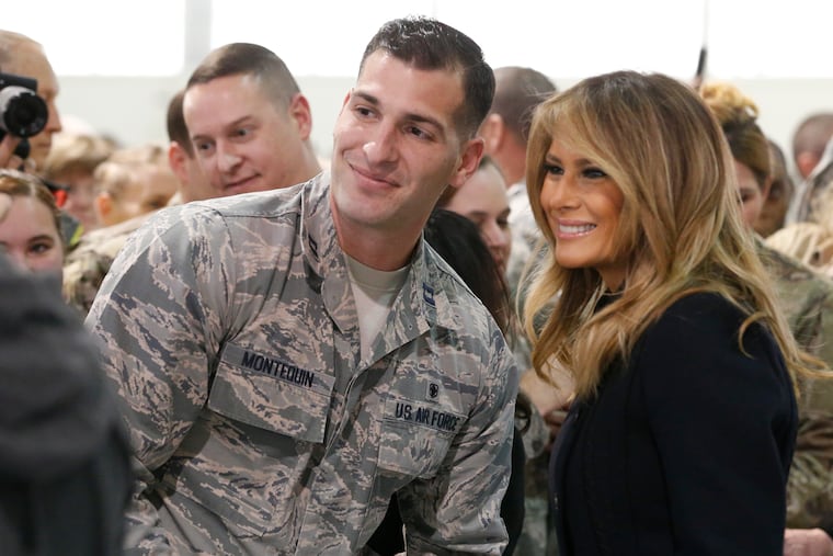 First lady Melania Trump , right, poses with an airman during a tour of Joint Base Langley in Hampton, Va., Wednesday, Dec. 12, 2018. (AP Photo/Steve Helber)
