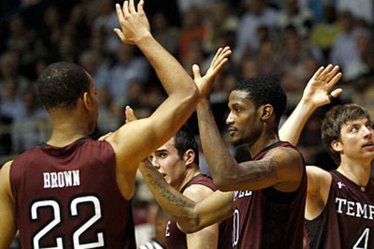 Temple players high-five each other after an overtime basket. (Yong Kim/Staff Photographer)