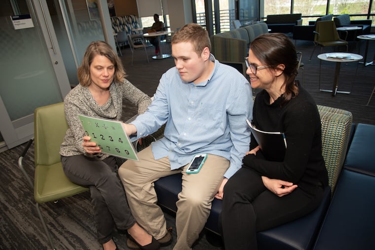 A patient and his mother (left) work with Dr. Wendy J. Ross, director of Jefferson Health’s Center for Autism and Neurodiversity.