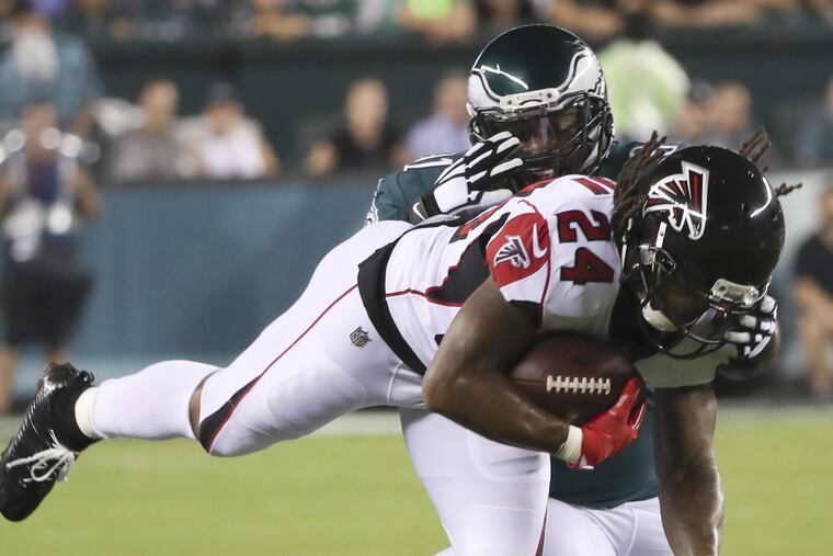 Fletcher Cox stops Falcons running back Devonta Freeman during the first quarter.