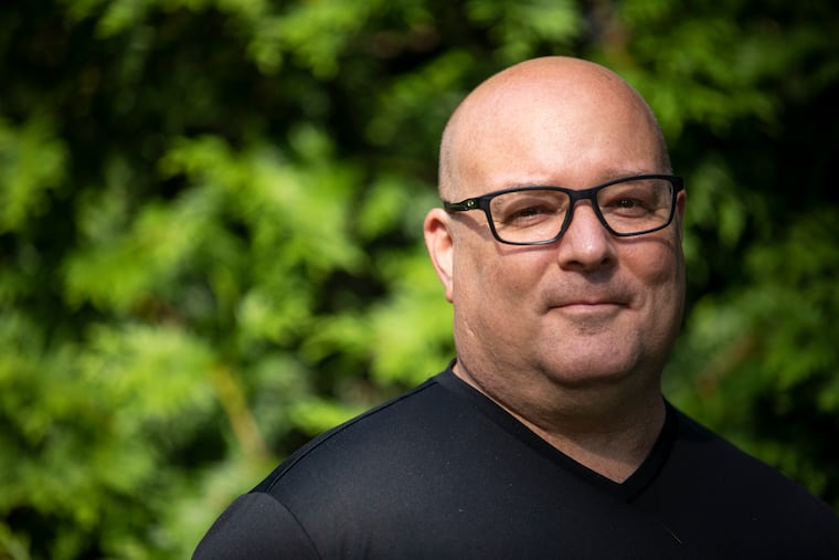Brett Breslow outside of his home in Cherry Hill. Breslow spent weeks in a medically induced coma while fighting COVID-19, and now is on the mend.