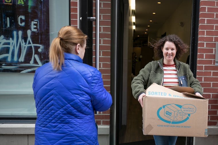 Liz Sewell carries a box of her belongings from her apartment at Fifth and South Streets to a rental Jeep before her drive to California for a new job. Sewell, unlike millions of Americans, got a dream job in her parks and recreation field, just as the the coronavirus (COVID-19) was crashing down.