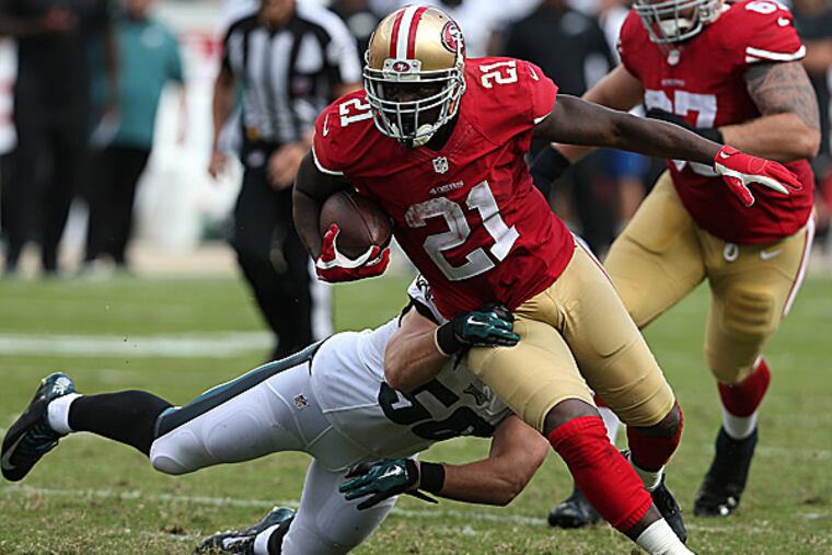 Eagles linebacker Casey Matthews can't tackle 49ers running back Frank Gore. (David Maialetti/Staff Photographer)