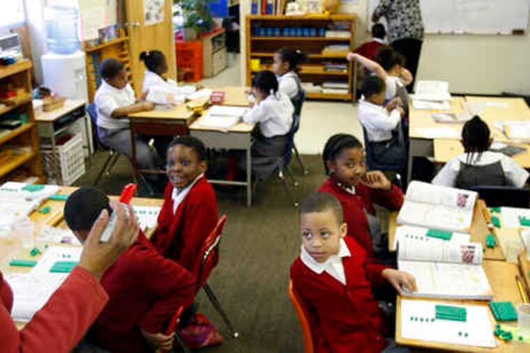 Eleanor Childs (left) gives a math lesson to kids at the Montessori Genesis II school in Mantua last month.