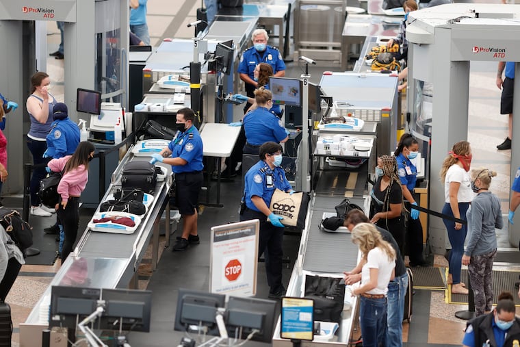 TSA agents process passengers at the south security checkpoint at Denver International Airport in Denver, as travelers deal with the effects of the new coronavirus. TSA, the government agency that oversees air travel, said the number of passengers screened for flights topped one million in a day on Sunday, Oct. 18 for the first time since the coronavirus pandemic outbreak last March.