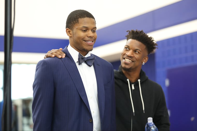 Jimmy Butler smiles at ex-Timberwolves and current Sixers teammate Justin Patton (left) at their introductory press conference.