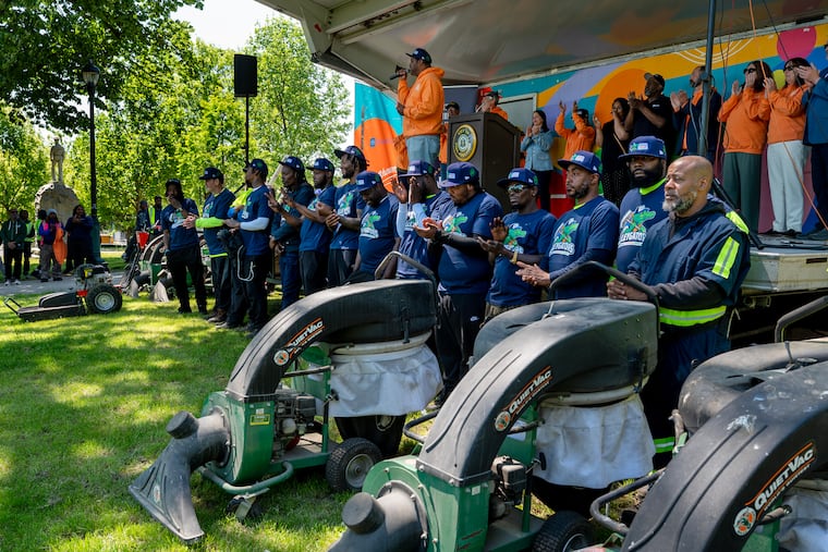 Carlton Williams, director of the Office of Clean & Green Initiatives, rallies the “AlleyGators” (in front) as city officials kick off the summer edition of the One Philly, United City citywide cleaning program in McPherson Park on Monday.