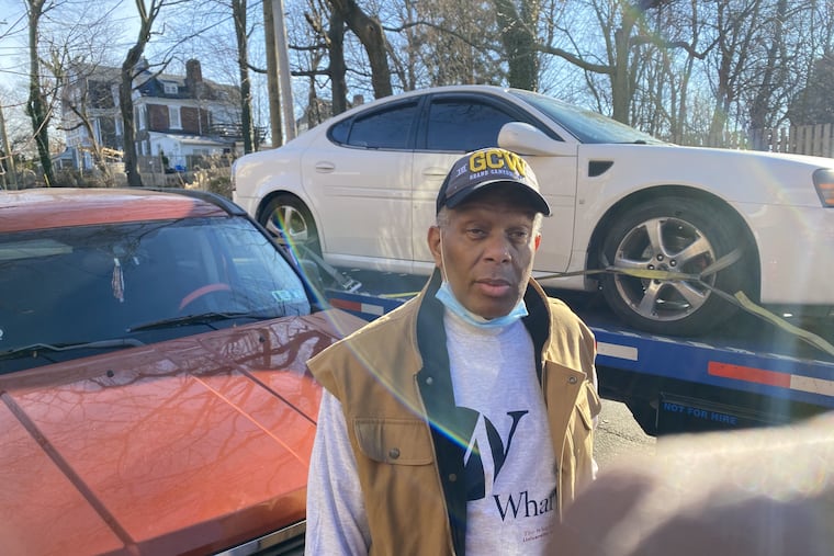 Oliver Neal, standing in front of his car on a flatbed truck, the day after an armed robber tried to steal it in West Mount Airy, he said. Neal shot the 16-year-old in the legs with a gun he is licensed to carry, police said.
