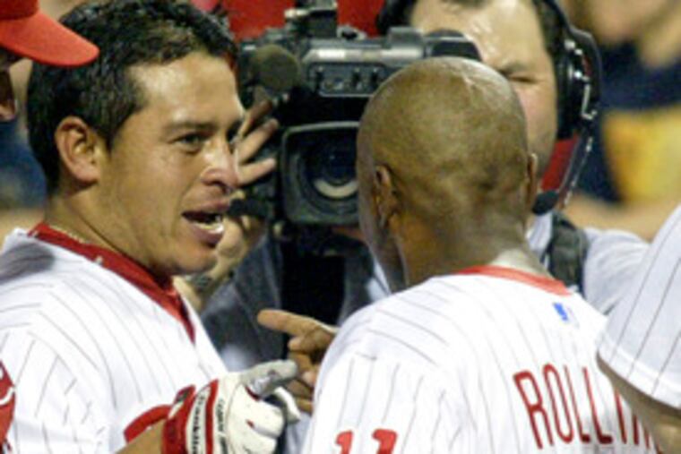 Carlos Ruiz celebrates winning home run with Jimmy Rollins.