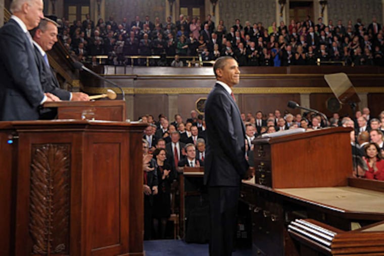 President Obama pauses before delivering his speech to a joint session of Congress. He said restoring a fair shot for all "is the defining issue of our time." He also said that "the state of our union is getting stronger."
