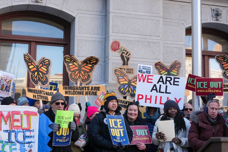Advocates and protesters gather Tuesday during a news conference at City Hall announcing a package of bills aimed at pushing back against ICE enforcement in Philadelphia.