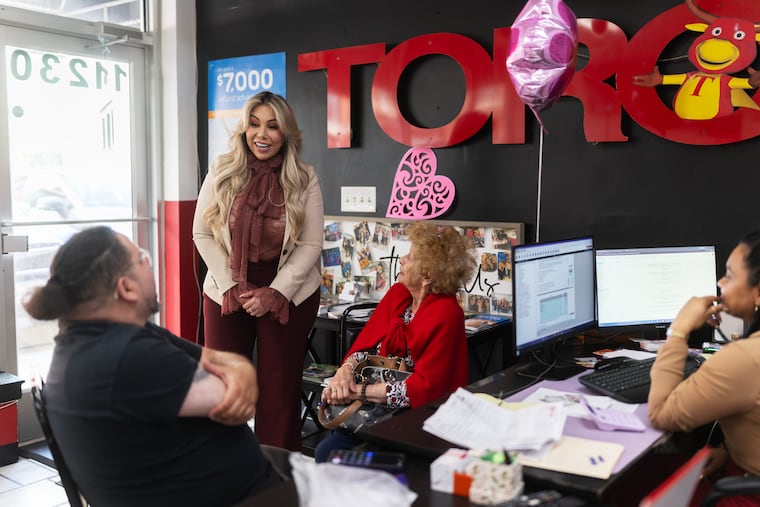 Accountant María José Solís speaks with clients at Toro Taxes on Monday in Wheaton, Maryland.