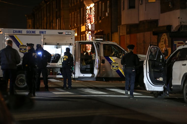Police process the crime scene on Jackson Street, where Eloise Harmon, 55, was fatally shot on the sidewalk on Wednesday.