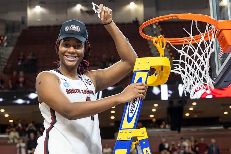South Carolina's Aliyah Boston holds up her piece of the net after defeating Maryland in the Elite 8 on March 27. Boston has announced her intention of declaring for the WNBA Draft.