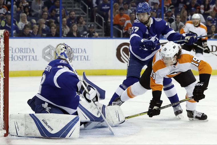 Flyers rookie center Nolan Patrick (19) gets knocked down by Tampa Bay defenseman Victor Hedman after scoring his 10th goal in the first period Saturday.