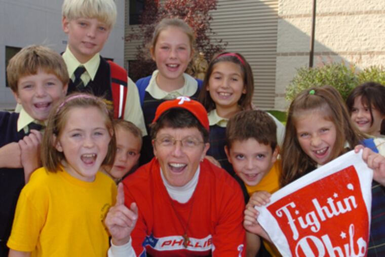 Wearing a Phillies t-shirt and baseball hat, Sister Elizabeth Anne DeWaele and some of the students from St. Thomas Apostle School in Glen Mills give a shout out for the Phillies as the number one team in baseball. (Clem Murray / Staff Photographer)