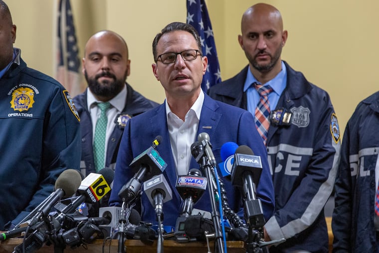 Gov. Josh Shapiro, center, speaks during a press conference regarding the arrest of suspect Luigi Mangione in Hollidaysburg, Pa., in the fatal shooting of UnitedHealthcare CEO Brian Thompson.