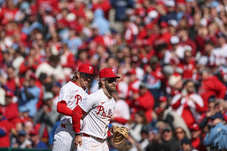 Phillies second baseman Bryson Stott celebrates a defensive play with Phillies first baseman Bryce Harper, but it's their plate discipline that's propelled the Phils to a 34-14 record.