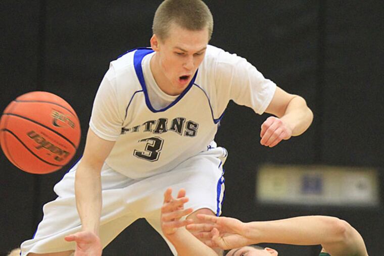 Pennridge's Zach Muredda (right) Pennridge struggles to pass to a teammate after slipping to the floor as C.B. South's Shane Degman applies defensive pressure. (Charles Fox/Staff Photographer)