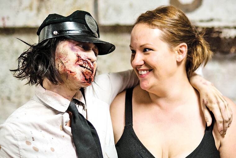 "Terror Behind The Walls" zombie Jenny Tomczak compliments Make-Up Director Lauren Palmer's work during a staff training at the Eastern State Peninentiary September 11th. September 11, 2014, Philadelphia, Pennsylvania. ( MATTHEW HALL / Staff Photographer )