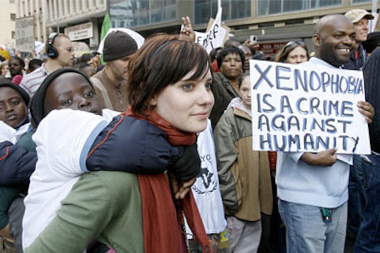 Thousands of protesters march downtown Johannesburg, South Africa to protest the recent wave of attacks against foreigners that left over 40 dead and scores homeless.(AP Photo/Jerome Delay)