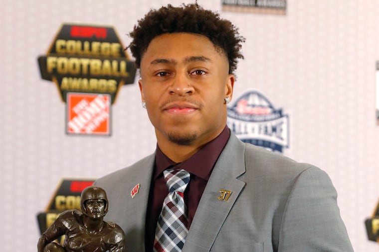 Wisconsin's Jonathan Taylor poses with the trophy after winning the Doak Walker Award as top running back in college football, Thursday, Dec. 6, 2018, in Atlanta. (AP Photo/John Bazemore)