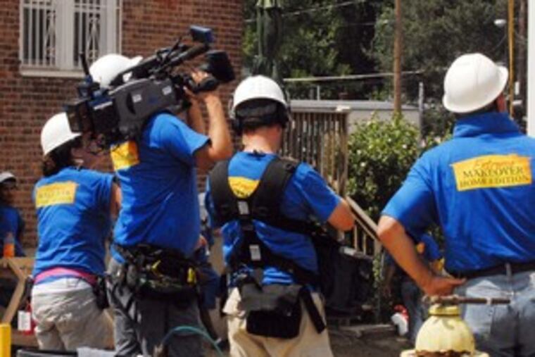 "Extreme Makeover" films volunteers as they hurriedly build the home.
