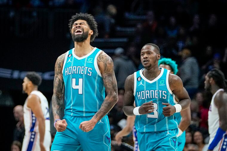 Charlotte Hornets center Nick Richards (4) celebrates beside Terry Rozier (3) as Sixers forward Tobias Harris, left, and Montrezl Harrell, right, walk away. (AP Photo/Rusty Jones)