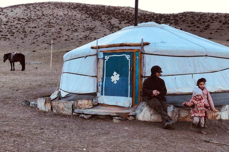 On a mid-May family trip to Mongolia from the Siberian city of Irkutsk, Brendan Jones sits outside their ger — elsewhere known as a yurt — with daughters (left) Kiera-Lee, 2, and Haley, 4.