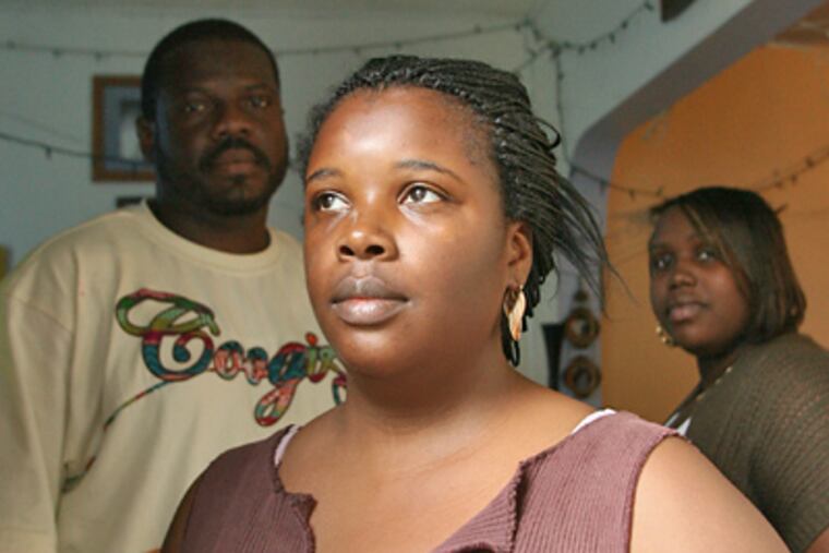 Family members of a girl allegedly raped by a neighbor. To the left is a man who beat the suspect, but has been prosecuted for it. (Yong Kim / Staff Photographer)