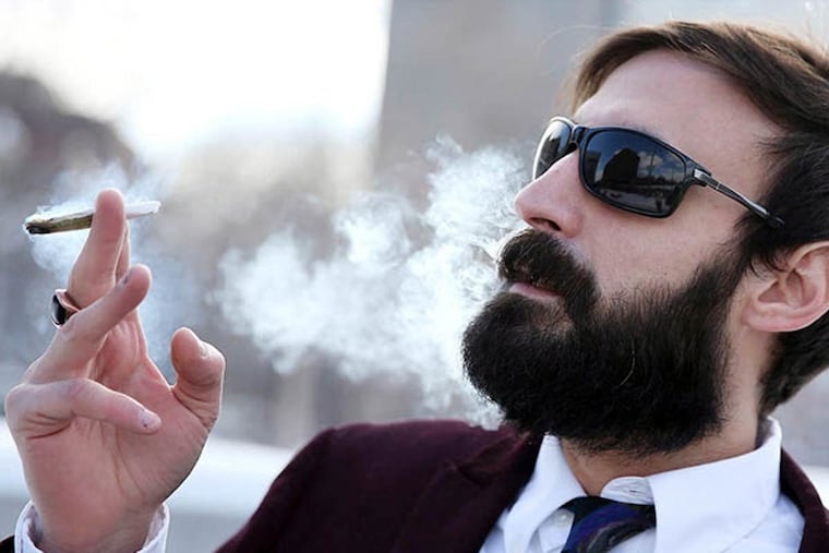 Marijuana activist N.A. Poe smokes a joint on Independence Mall in Philadelphia in February 2015.