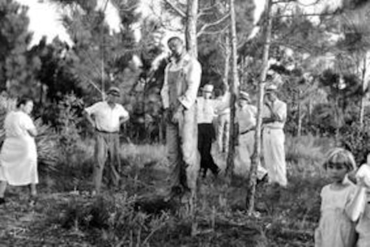 A group of people look at the body of Rubin Stacy, 32, who was lynched July 19, 1935, in Fort Lauderdale, Fla., for allegedly having attacked a white woman.