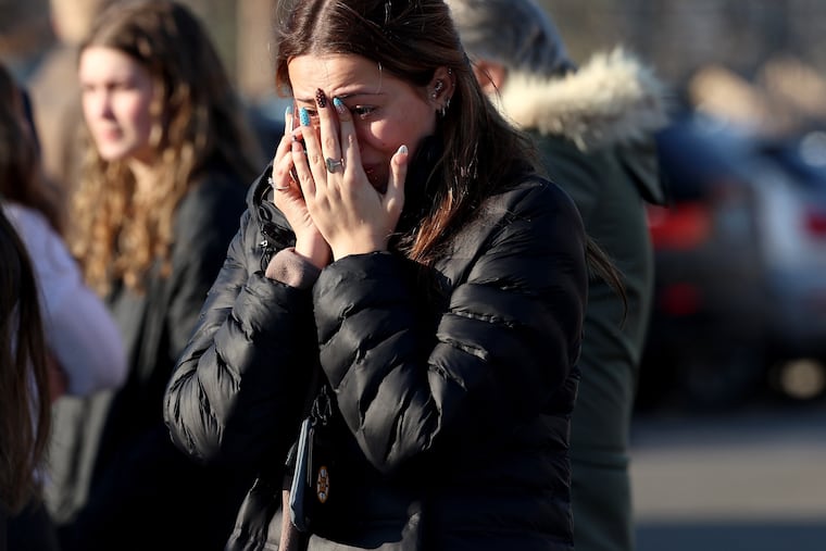 A woman reacts near the Lynch Arena in Pawtucket, R.I., after a shooting at the ice rink, Monday, Feb. 16, 2026.