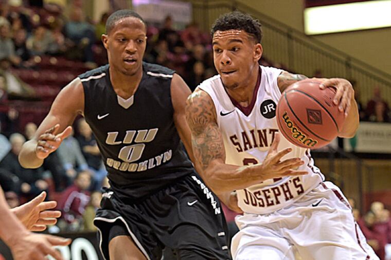Saint Joseph's guard Chris Wilson drives past Long Island guard Trevin Woods. (Eric Hartline/USA Today Sports)