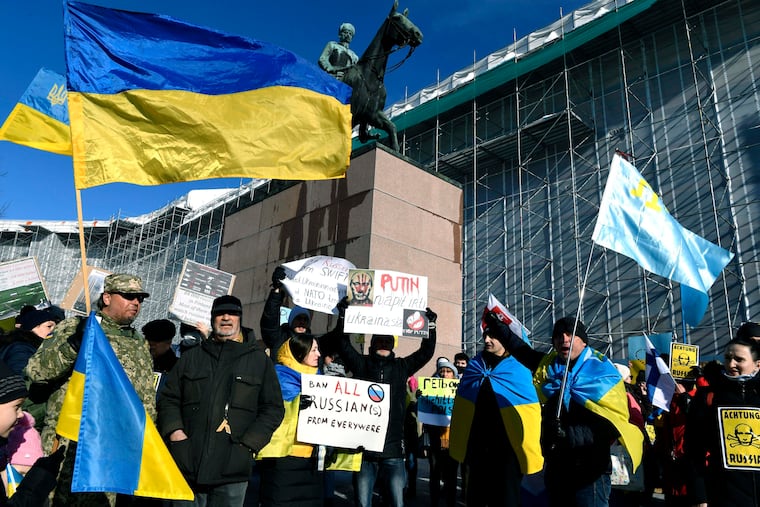 People take part in a demonstration in support of Ukraine, in Helsinki, Finland, Saturday, Feb. 26, 2022. Russian troops stormed toward Ukraine's capital Saturday, and street fighting broke out as city officials urged residents to take shelter.